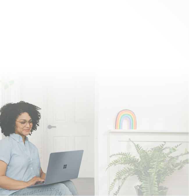 Woman sitting on a couch with a laptop