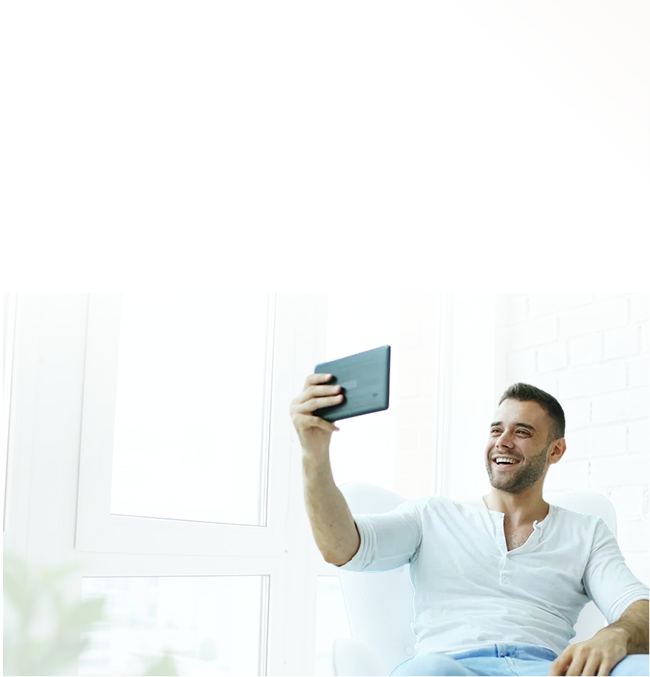 Man sitting on a couch looking at his phone